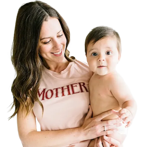 Brunette woman wearing a pink shirt that says 'Mother', she's holding a chubby brunette baby boy